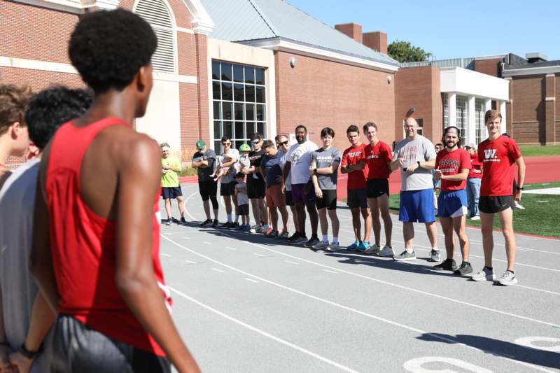 a group of people standing on a track