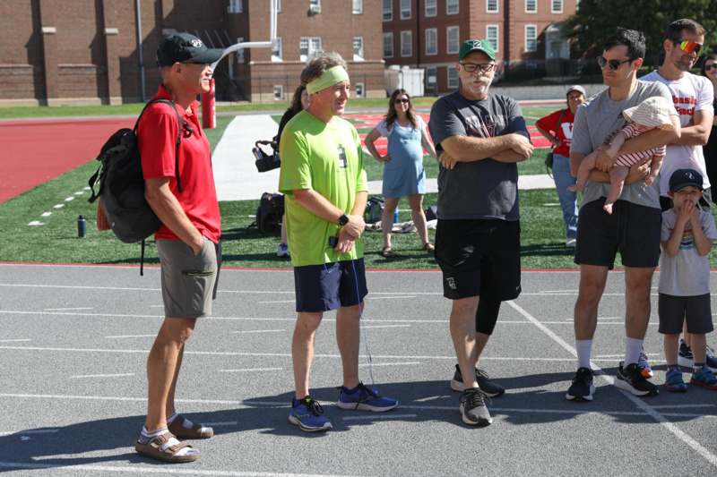 a group of people standing on a track