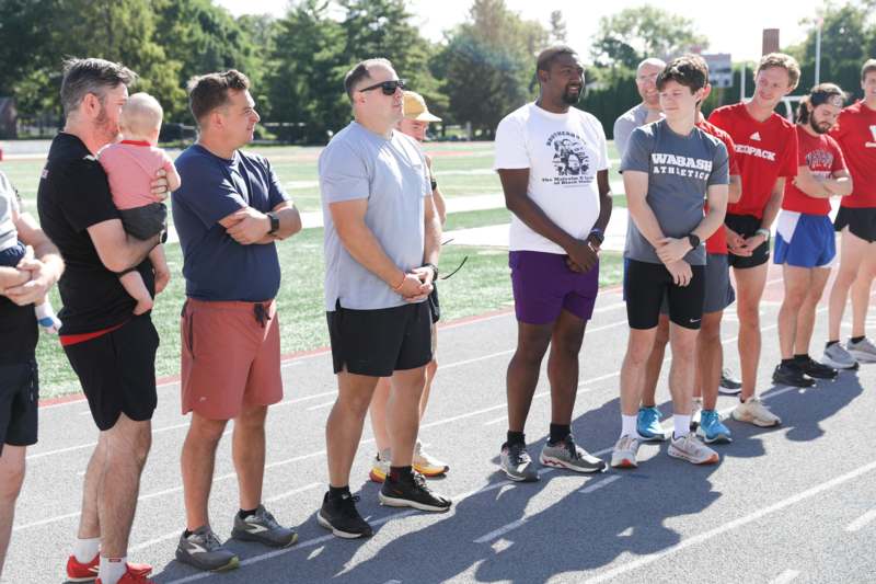 a group of people standing on a track