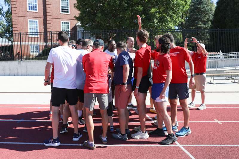 a group of people standing on a track