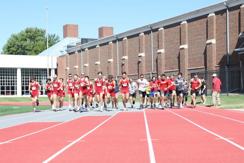 a group of people running on a track