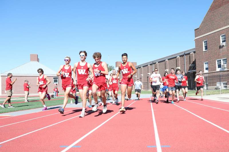 a group of people running on a track