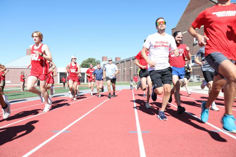 a group of people running on a track