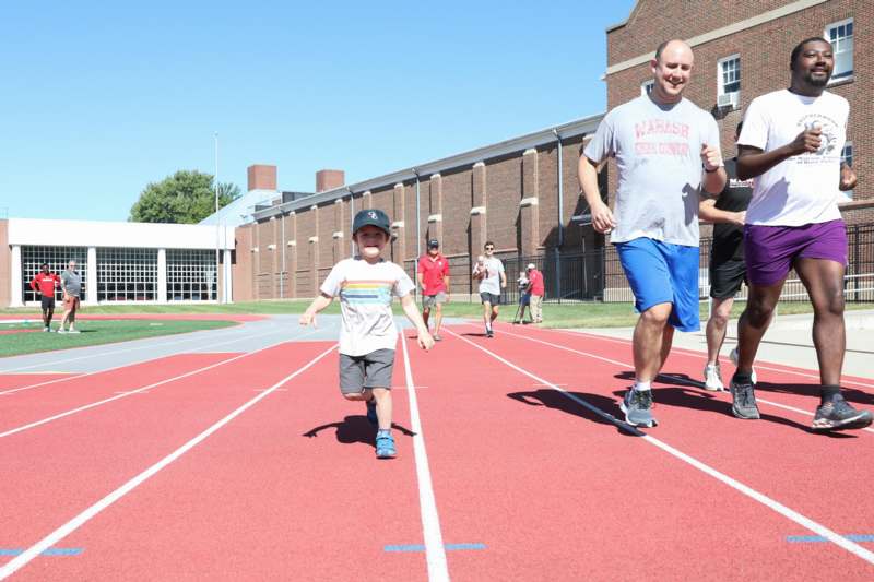 a group of people running on a track