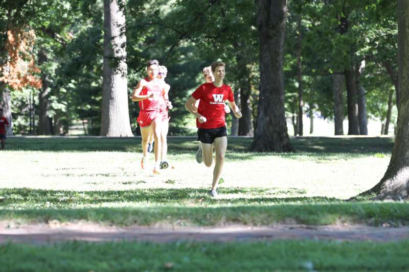 a group of people running in a park