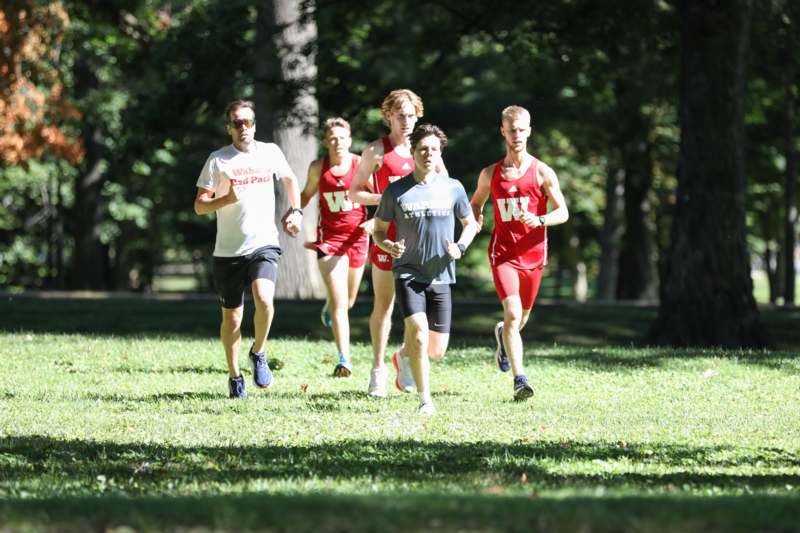a group of people running in a park