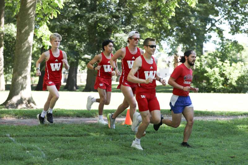 a group of men running in a park