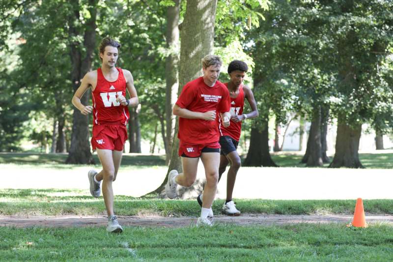 a group of men running in a park