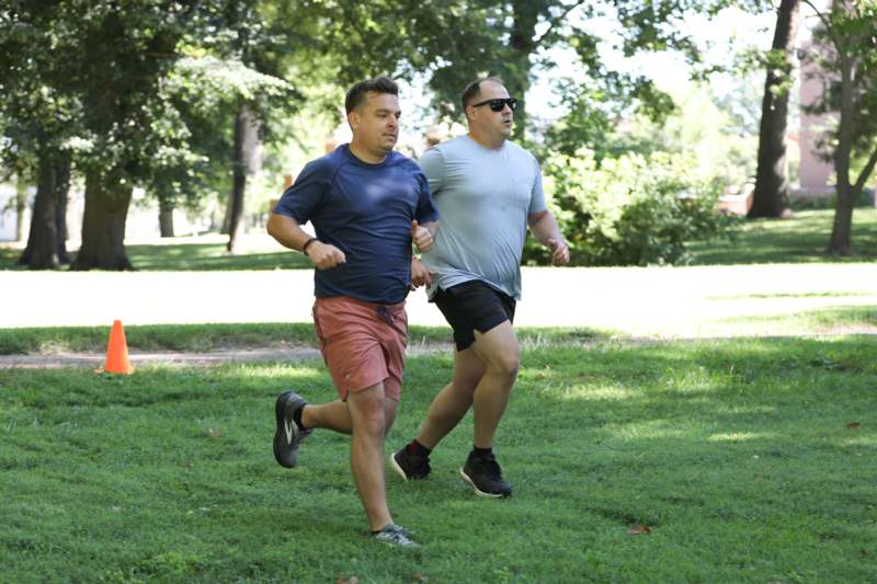 two men running in a park