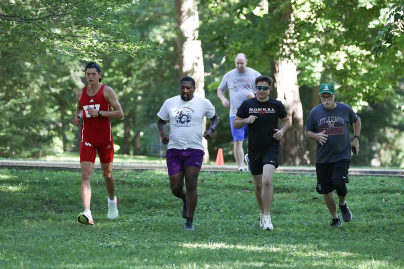 a group of people running in a park