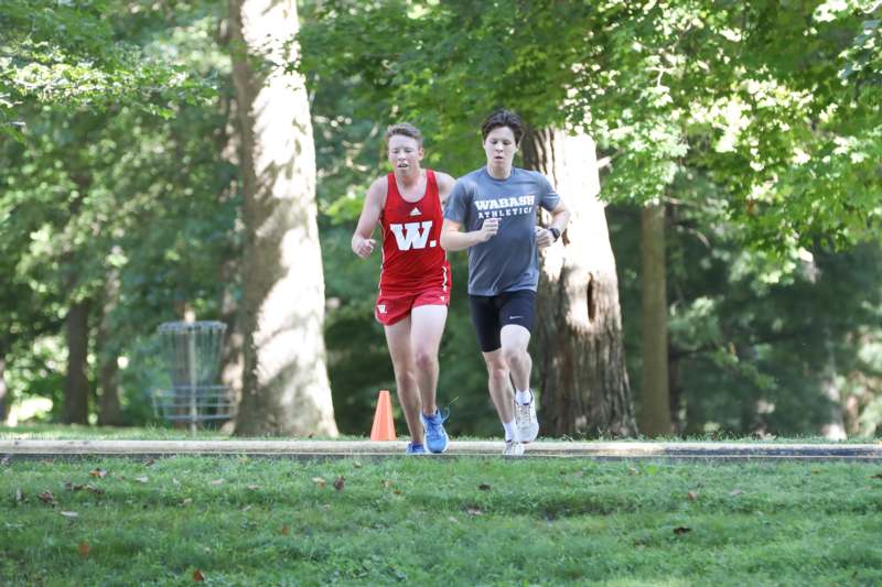 two people running in a park