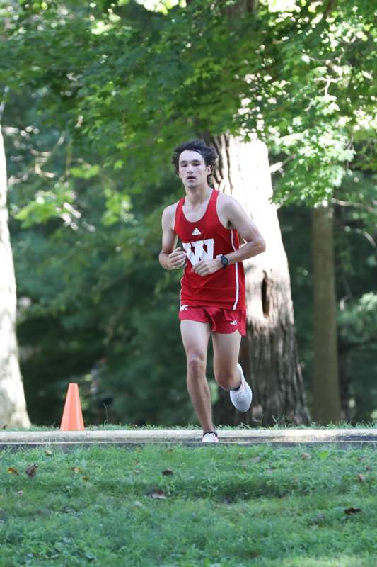 a man running in a red shirt
