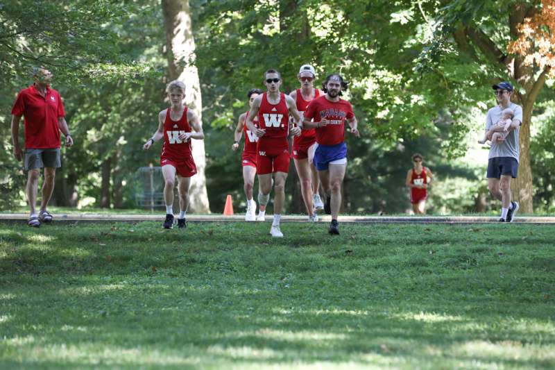 a group of people running in a park