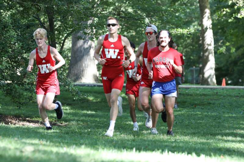 a group of people running in a park