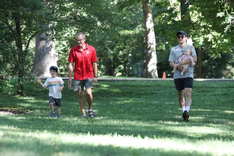 a group of people walking in a park