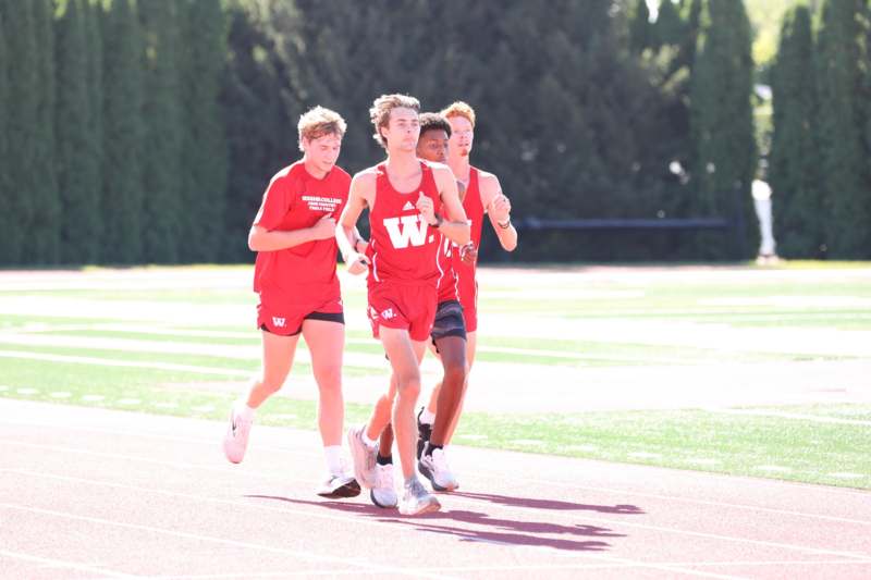 a group of men running on a track