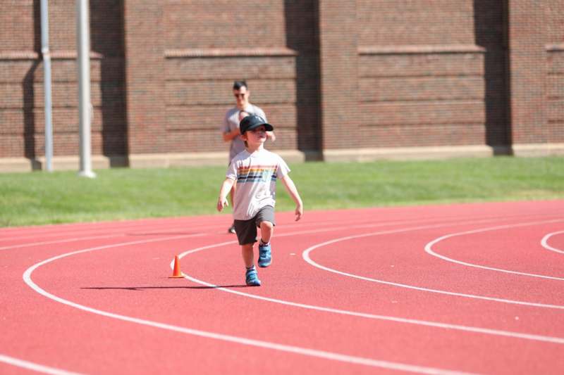 a boy running on a track