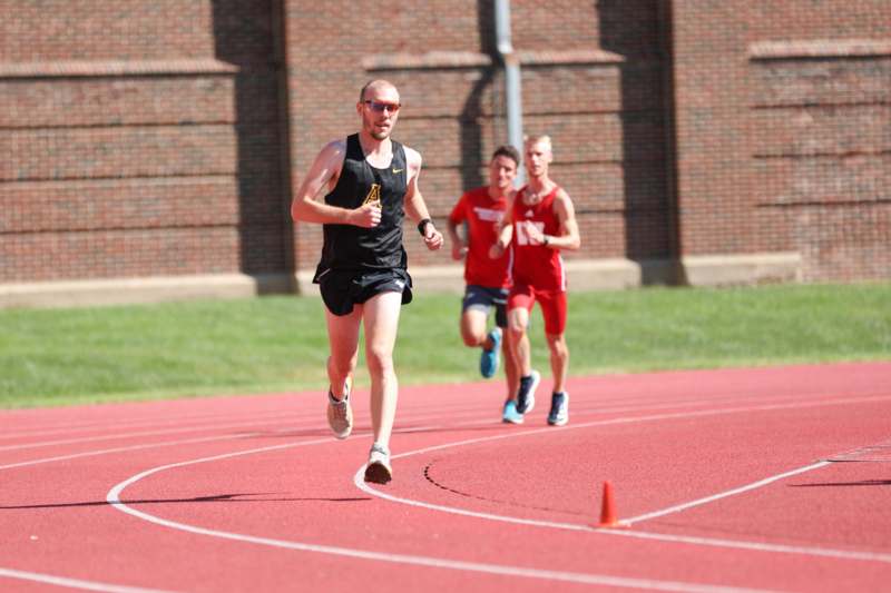 a group of men running on a track