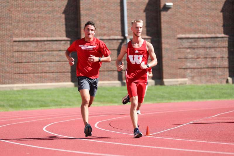 a group of men running on a track