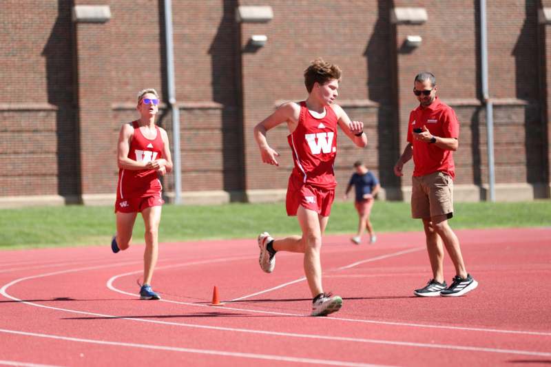 a group of people running on a track