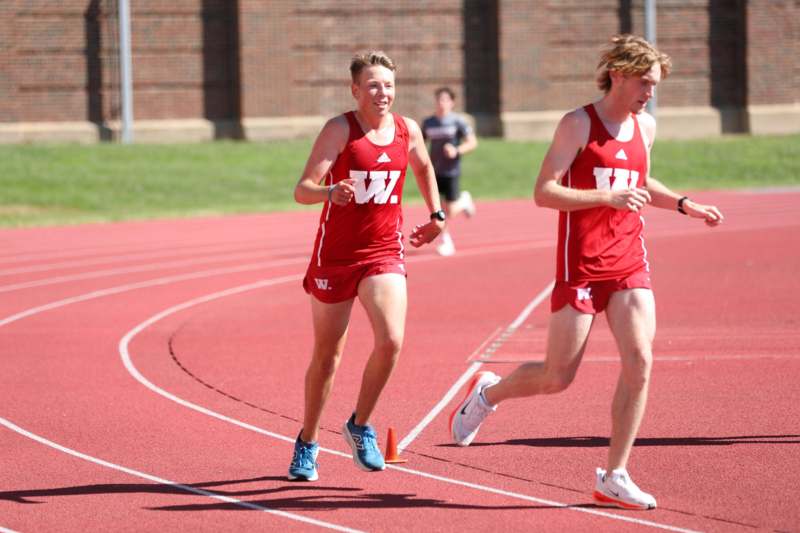 two men running on a track