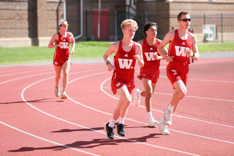 a group of people running on a track