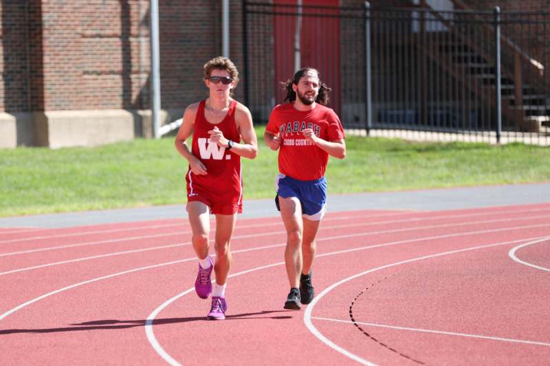 two men running on a track