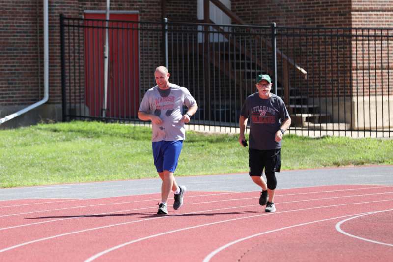 two men running on a track