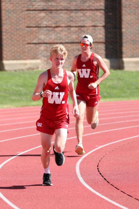 a couple of people running on a track