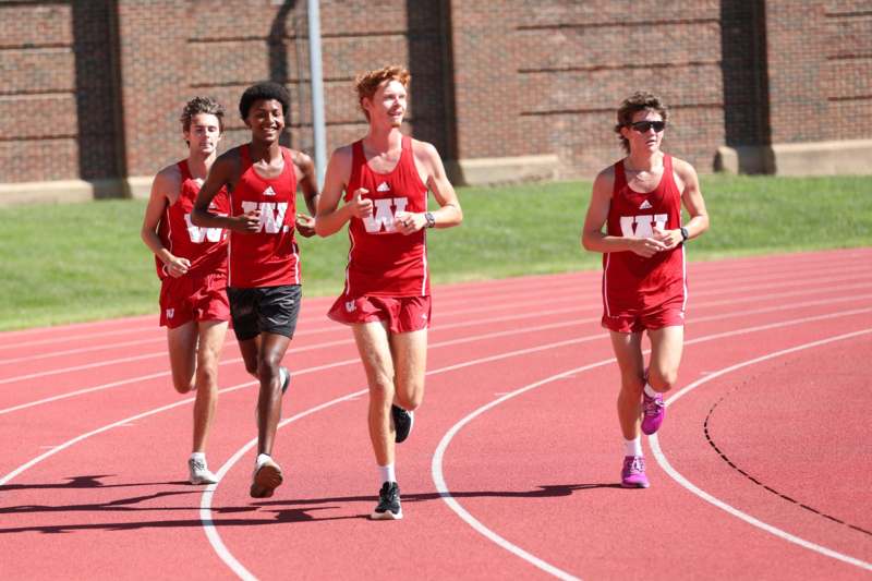 a group of men running on a track
