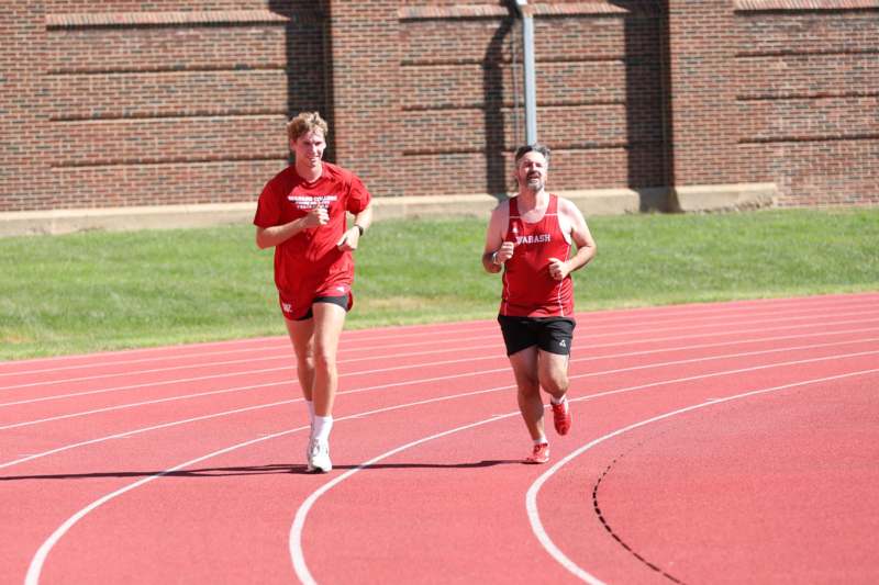 two men running on a track