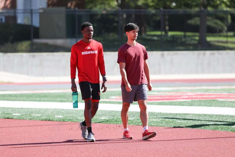 two men walking on a track
