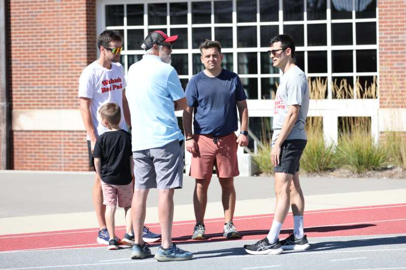 a group of men standing on a track