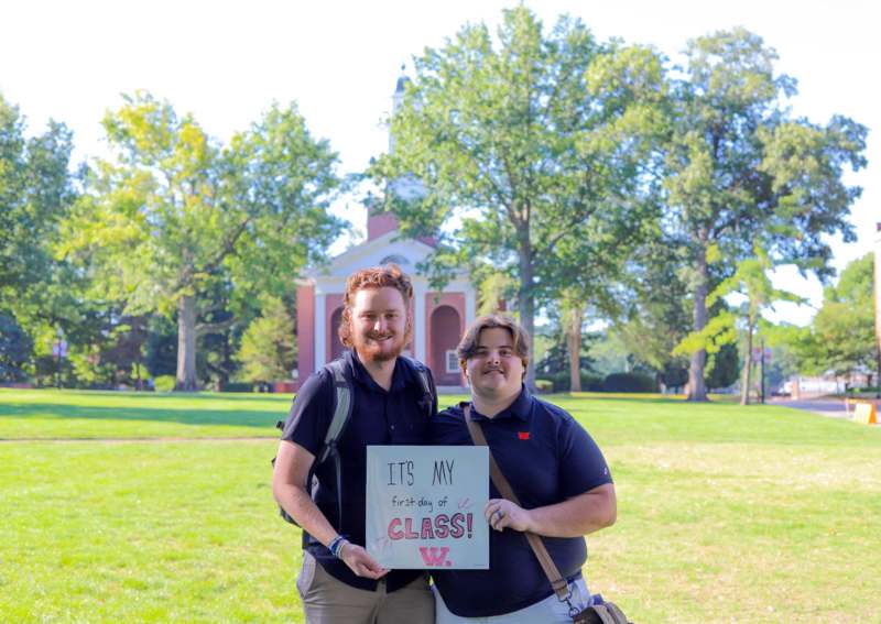 two men holding a sign