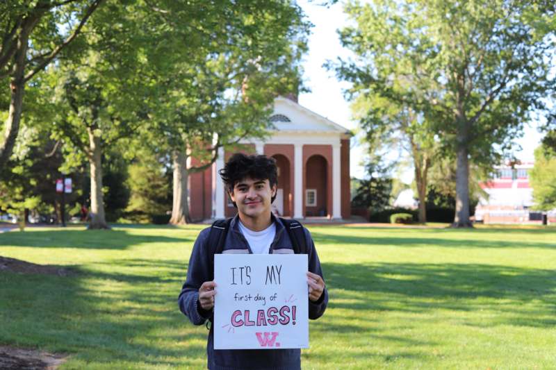 a man holding a sign in front of a building