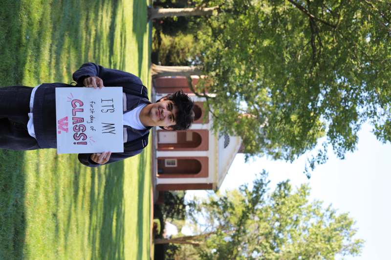 a man holding a sign in front of a building