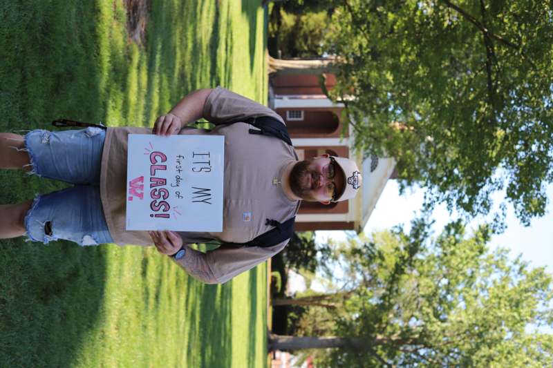 a man holding a sign