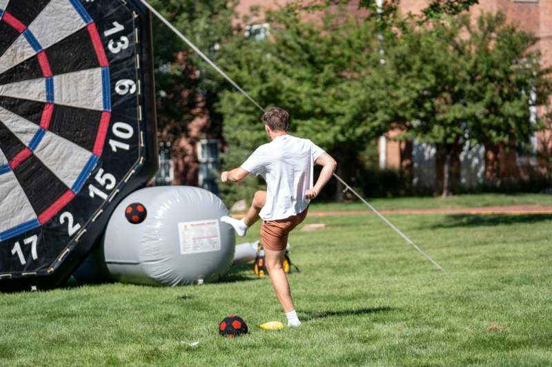 a man kicking a ball in a grass field