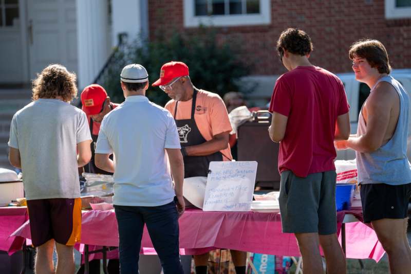 a group of people standing around a table