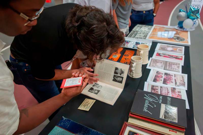 2025 Phi Delta Theta 175th Anniversary Celebration - a person looking at a book