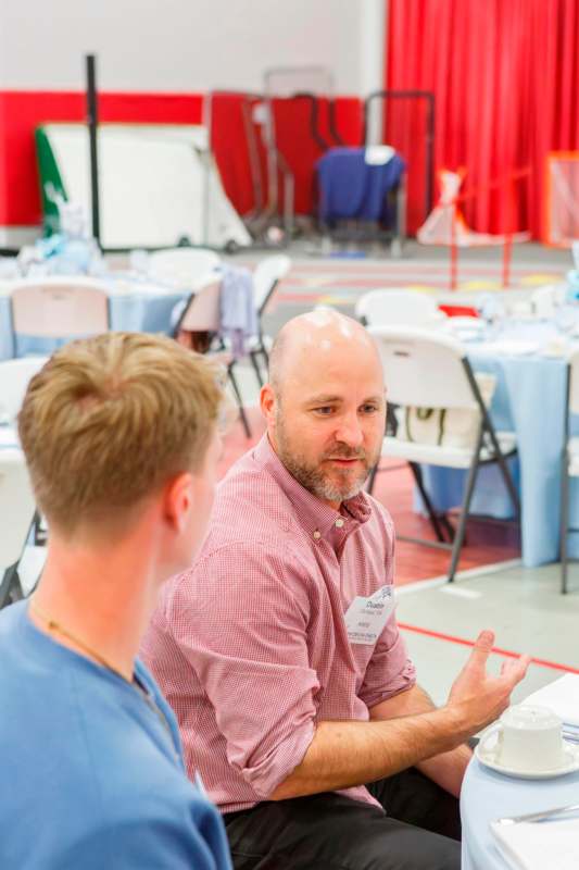 a man talking to another man