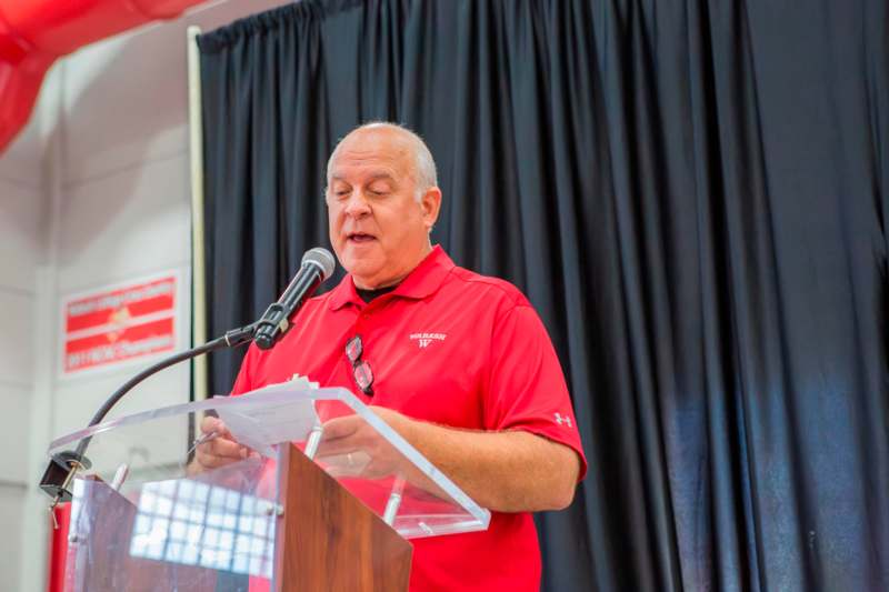 a man standing at a podium with a microphone