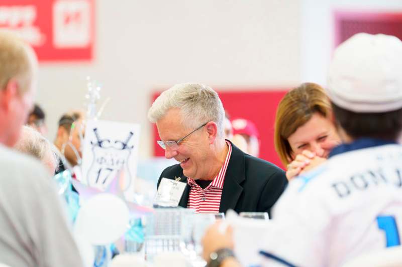 a group of people laughing at a table