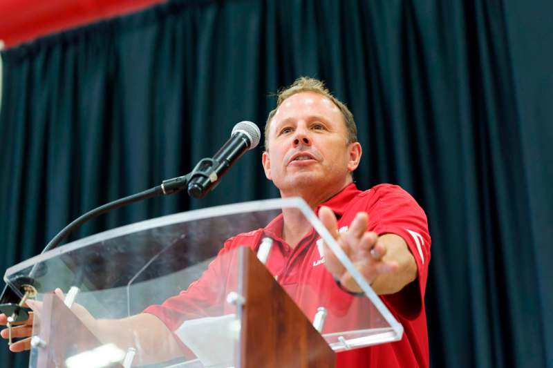 a man standing at a podium with a microphone
