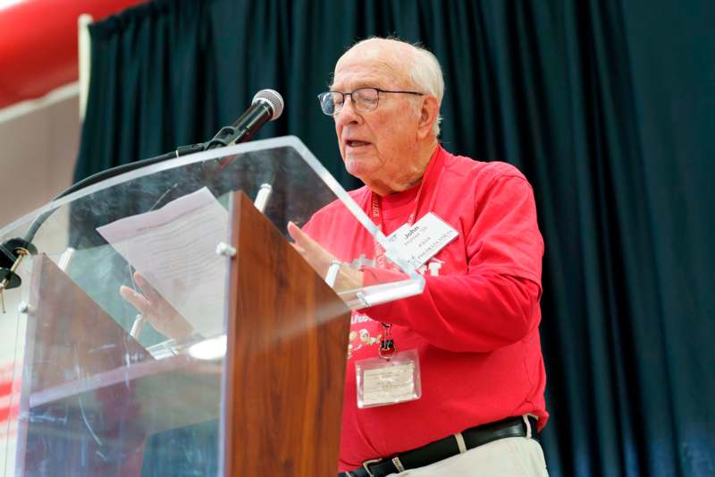 an old man standing at a podium