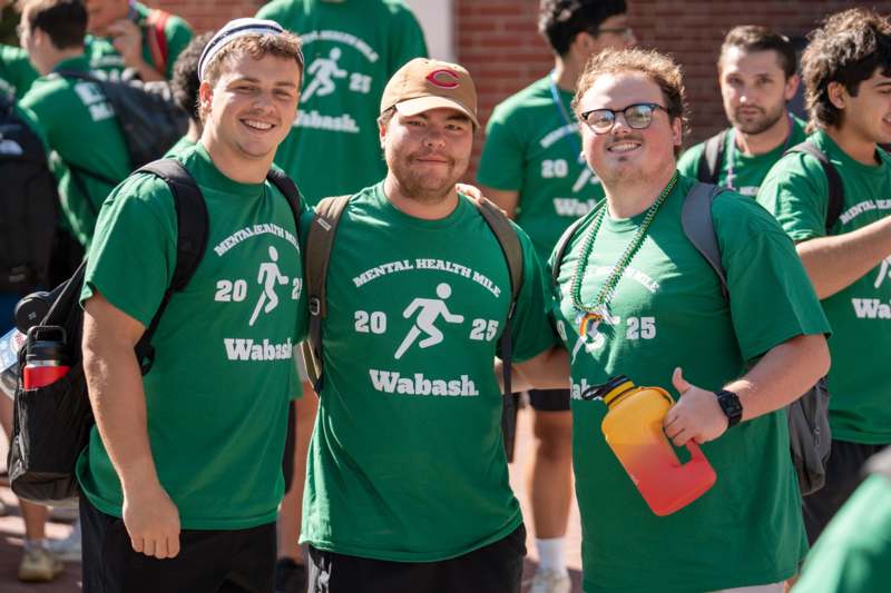 a group of men wearing green shirts