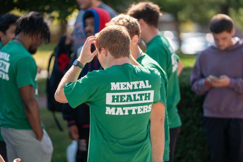 a group of people in green shirts