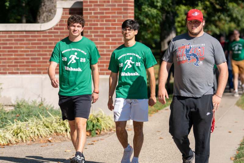 a group of men walking on a sidewalk
