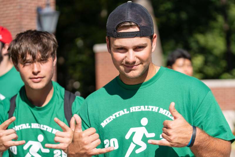 a group of men in green shirts