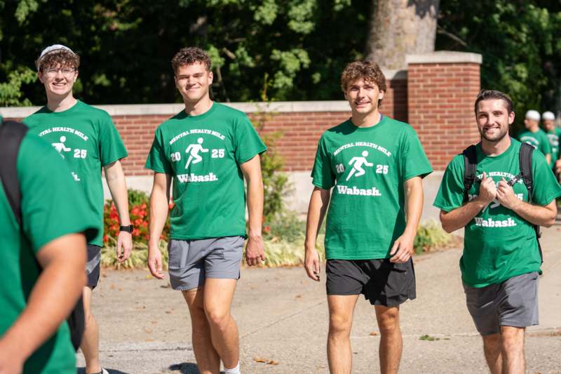 a group of men wearing green shirts